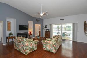 a living room with two chairs and a ceiling fan at Foxrun Terrace Luxury 5BR Pool Villa in Inverness