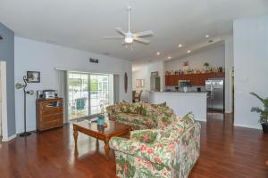 a living room with two couches and a table at Foxrun Terrace Luxury 5BR Pool Villa in Inverness