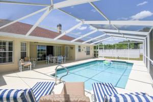 a swimming pool with a retractable roof at Foxrun Terrace Luxury 5BR Pool Villa in Inverness