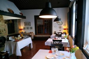 a restaurant with two tables with white tablecloths at Quinta da Travessa - Douro in Covelinhas
