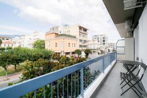 a balcony with a view of a street and buildings at Belajo Central Apartment And Jacuzzi !! in Volos