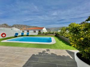 a swimming pool in the yard of a house at Casitas Sierra de Libar in Montejaque