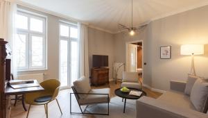 a living room with a couch and chairs at Vju Hotel Rügen in Göhren