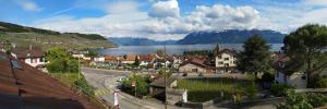 a town with a view of a river and a city at Charmante maison au coeur du Lavaux, Cully, cuisine, WiFi, Les Echalas in Cully