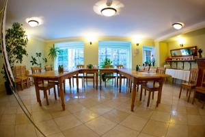 a dining room with wooden tables and chairs at Mathias Rex in Szentendre
