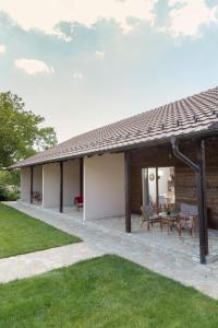 a house with a patio and a roof at Aqualux apartments in Vrdnik