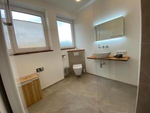 a bathroom with a sink and a toilet at Ferienwohnung im Stadtzentrum in Oberstaufen