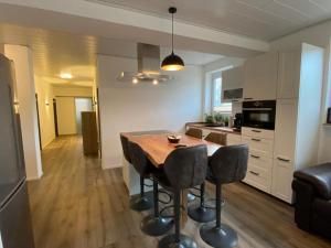 a kitchen with a table and chairs in a room at Ferienwohnung im Stadtzentrum in Oberstaufen +9 photos