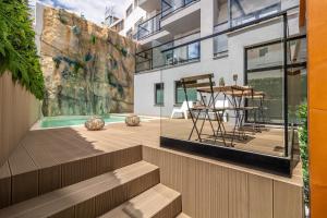 a building with a patio with a table and chairs at Roots Hotel in Faro