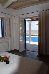 a bedroom with a bed and a view of a pool at Villa Irini in Panormos Mykonos