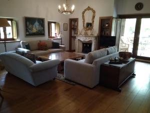 a living room with couches and a table and a fireplace at Casa Rural San Pelayo in Camaleño