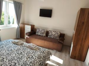 a bedroom with a bed and a couch at Bubolina House in Sapareva Banya