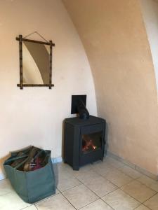 a fireplace in a room with a bag next to it at Gite Montalies in Novis