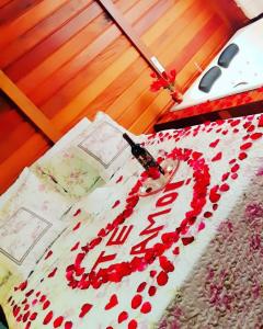 a bed with a cake with the word love on it at Recanto Della Mata in Venda Nova do Imigrante