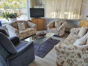 a living room with two couches and a tv at Ferienwohnung Schlossblick Bad Breisig in Bad Breisig