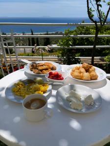 a table with plates of food and a cup of coffee at Persephone in Himare
