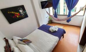 a living room with a bed and a couch at Erupcion Art Hotel & Hostel in Baños