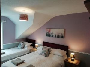 two beds in a room with a attic at Shirley Heights Hotel in Blackpool