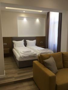 a bedroom with a bed and a couch at Hotel House K21 in Sofia +17 photos
