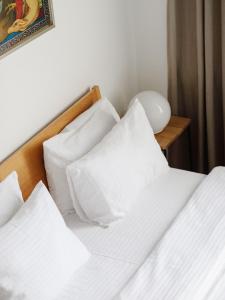 a bedroom with two beds with white pillows at Mariinsky Boutique Hotel in Batumi