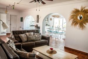 a living room with a couch and a table at Villa Las Palmeras with private pool and garden in Altea