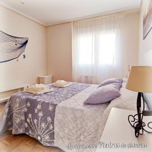 a bedroom with a bed and a window at PIEDRAS DE ASTURIAS in Piedras Blancas +38 photos