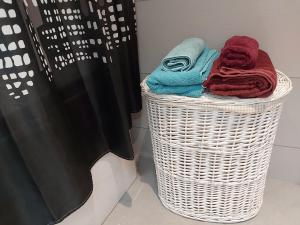 a white laundry basket with towels in a bathroom at Sunny Beach Apartment in Narva-Jõesuu