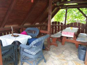 a patio with a table and chairs in a pavilion at Tavasz Nyaraló in Poroszló