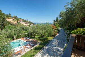 an external view of a villa with a swimming pool at Evridiki's Villas in Agios Nikitas