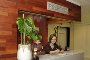 a woman sitting at a counter in front of a mirror at Jugendhotel Bachlehen und Johanneshof in Radstadt +133 photos