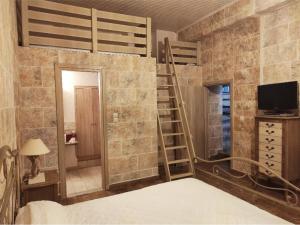 a bedroom with a bunk bed and a tv at Perimenis Seaside House in Gerolimenas