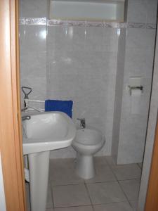 a bathroom with a sink and a toilet at Casa Miclara Appartamento -- Limoni in Zanca
