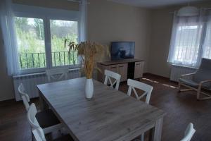 a table with a vase on it in a living room at La Casa Del Rio in Granja Llumes