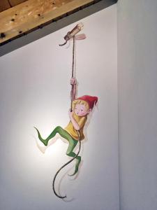 a painting of a girl on a rope with a bird at Rifugio Monti Pallidi in Canazei