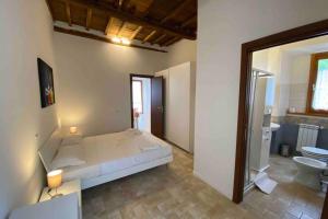 a large bedroom with a bed and a bathroom at Sasso Grosso House in Ronciglione