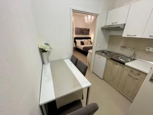 a kitchen and living room with a counter top in a room at Central Square Guest House in Zadar