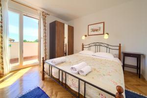 Postel nebo postele na pokoji v ubytování Apartments Rose