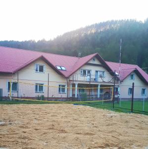 une maison avec des toits roses et un champ de terre dans l'établissement Promenada, à Węgierska Górka