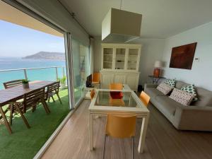 a living room with a view of the ocean at CLP- Primera linea vistas piscina y parking in Calpe