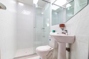 a bathroom with a toilet and a sink and a shower at Ayenda Hotel Casona Santa Rosa in Chía