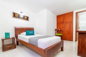 Giường trong phòng chung tại Ayenda Hotel Casona Santa Rosa