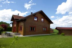 a wooden house with a picnic table in the yard at Holzblockhaus Franziska in Plattling