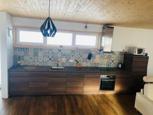 a kitchen with a counter top and a window at Villa Alma Arlberg in Warth am Arlberg