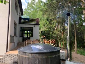a hot tub in the backyard of a house at Willa nad Pilicą in Promna