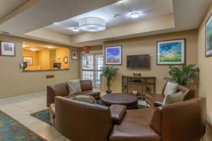 a waiting room with couches and a flat screen tv at Candlewood Suites South Bend Airport, an IHG Hotel in South Bend