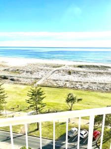 a view from a balcony of a beach with a view of the ocean at Meridian Tower Kirra Beach in Gold Coast