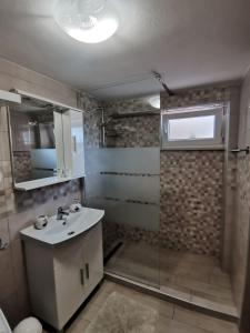 a bathroom with a sink and a shower at Apartment Maja in Bribir +15 photos