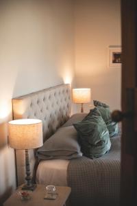 a bedroom with a bed with two lamps on it at Cedar House in Gisborne