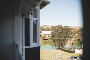 a window of a house with a view of a river at Cedar House in Gisborne