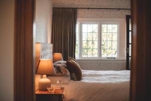 a bedroom with a large bed and a window at Cedar House in Gisborne
